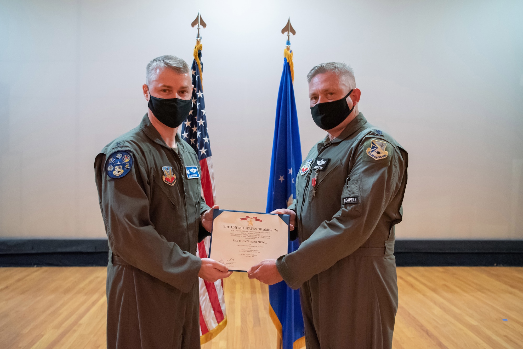 Two Airmen holding certificate