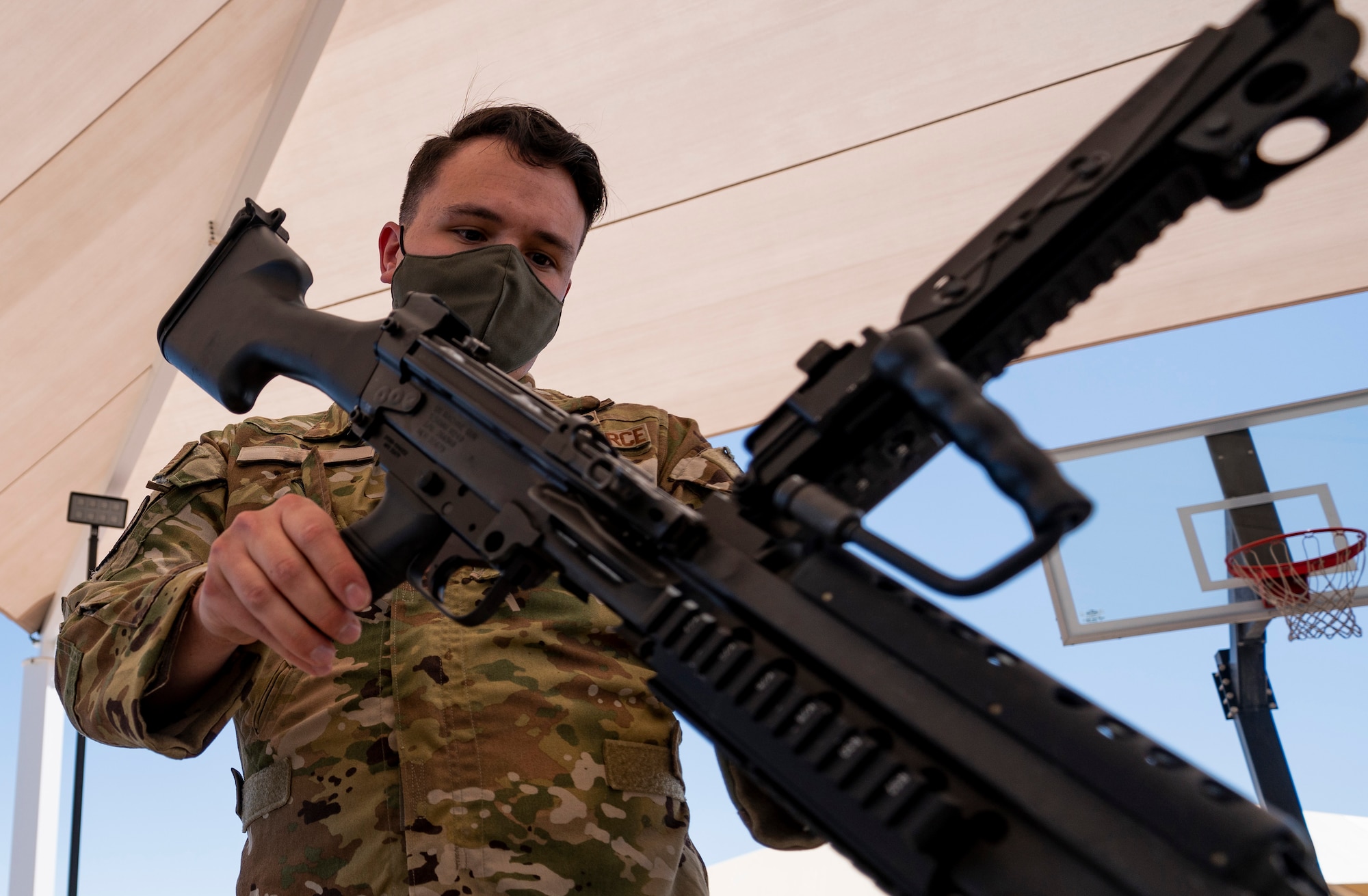 Airman inspects the barrel of a weapon.