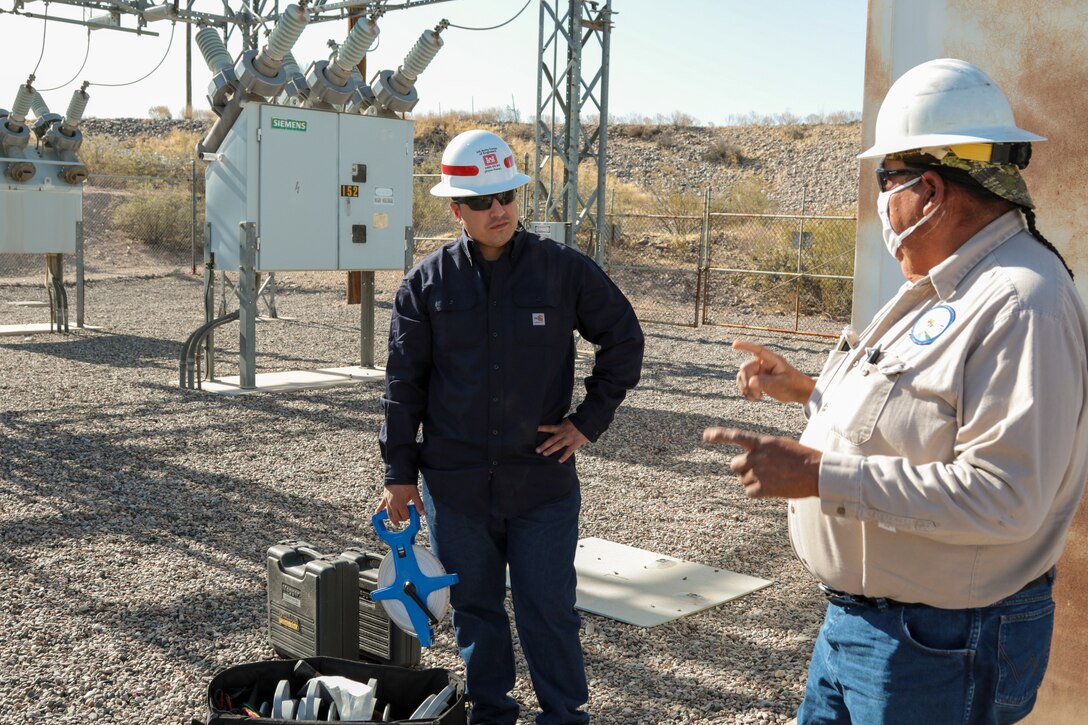George Gorman (right), a supervisory electrician with the San Carlos Irrigation Project, discusses site safety May 19 with Sgt. Eduardo Delacruz, Alpha Company, 249th Engineer Battalion, U.S. Army Corps of Engineers. Delacruz and Staff Sgt. Jacob Wratchford are testing a San Carlos Irrigation Project's substation grounding May 19 by testing soil conductivity. The 249th is charged with the rapid deployment of U. S. Army generators to support worldwide requirements.