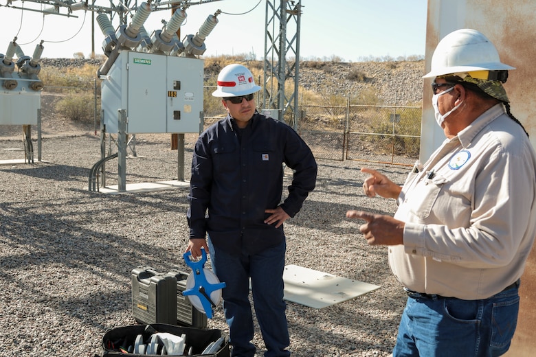 George Gorman (right), a supervisory electrician with the San Carlos Irrigation Project, discusses site safety May 19 with Sgt. Eduardo Delacruz, Alpha Company, 249th Engineer Battalion, U.S. Army Corps of Engineers. Delacruz and Staff Sgt. Jacob Wratchford are testing a San Carlos Irrigation Project's substation grounding May 19 by testing soil conductivity. The 249th is charged with the rapid deployment of U. S. Army generators to support worldwide requirements.