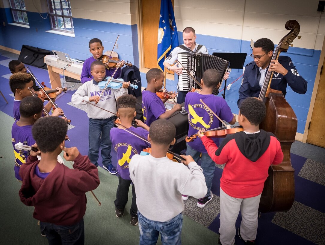 Accordionist Senior Master Sgt. Frank Busso and Bassist Technical Sgt. Victor Holmes play along with students from the West End School during an AIM event. (U.S. Air Force photo by Chief Master Sgt. (ret.) Bob Kamholz)