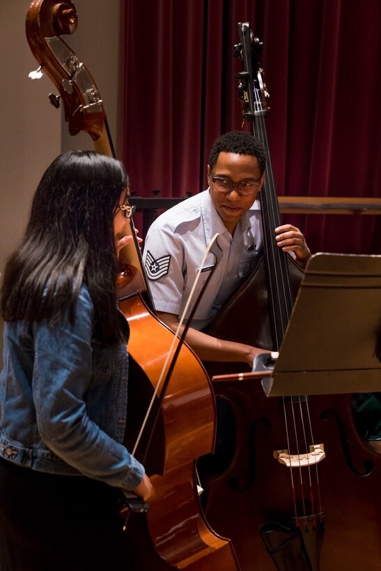 Bassist Technical Sgt. Victor Holmes coaches a student during a Concert Band AIM Side-By-Side event. (U.S. Air Force photo by Senior Master Sgt. Joshua Kowalsky)
