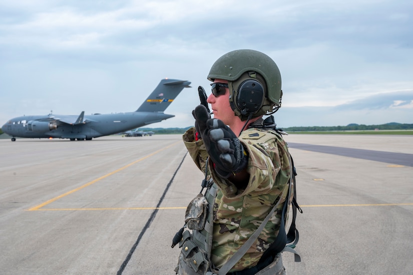 Staff Sgt. Nathan Adams, 1st Battalion, 623rd Field Artillery Regiment, Kentucky Army National Guard field artillery crew member guides an M142 High Mobility Artillery Rocket System off of a C-130J Super Hercules assigned to the 19th Airlift Wing at Volk Field Air National Guard Base, Wisconsin, May 20, 2021. The HIMARS is a multiple rocket launcher developed in the late 1990s for the U.S. Army, mounted on a standard Army M1140 truck frame and is vital to the joint force integration. (U.S. Air Force photo by Senior Airman Aaron Irvin)