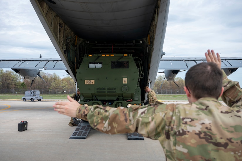 U.S. Air Force Senior Airman Noah Isom, 39th Airlift Squadron loadmaster, guides an M142 High Mobility Artillery Rocket System on to a C-130J Super Hercules assigned to the 19th Airlift Wing at Volk Field Air National Guard Base, Wisconsin, May 20, 2021. The HIMARS is a multiple rocket launcher developed in the late 1990s for the U.S. Army, mounted on a standard Army M1140 truck frame and is vital to the joint force integration. (U.S. Air Force photo by Senior Airman Aaron Irvin)