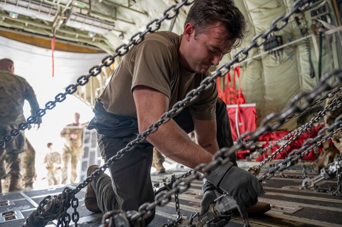U.S. Air Force Staff Sgt. Caleb Bowlick, 700th Airlift Squadron instructor loadmaster secure M142 High Mobility Artillery Rocket Systems to a C-130J Super Hercules assigned to the 19th Airlift Wing at Alpena Combat Readiness Training Center, Michigan, May 20, 2021. The HIMARS is a wheeled, all-terrain weather precision fire support system that provides strategic, long-range precision fires for a joint force. (U.S. Air Force photo by Senior Airman Aaron Irvin)