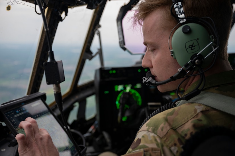U.S. Air Force Capt. Zachary Robinson, 39th Airlift Squadron pilot, checks a map while flying over Michigan during Mobility Guardian, May 20, 2021. Mobility Guardian includes AMC’s first large-scale training on Agile Combat Employment, setting the standard for the role mobility aircraft plays in projecting the joint force.