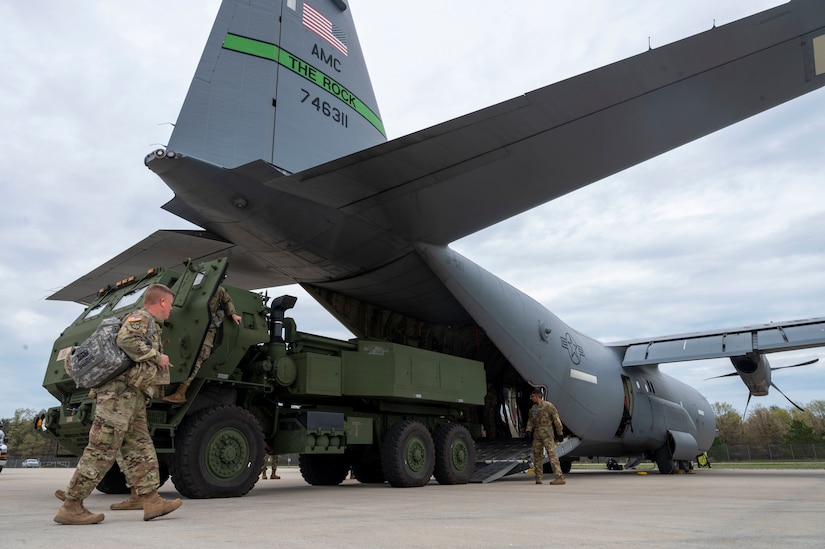 Loadmasters from the 39th Airlift Squadron and Soldiers assigned to 1st Battalion, 623rd Field Artillery Regiment, Kentucky Army National Guard, prepare to load an M142 High Mobility Artillery Rocket System on to a C-130J Super Hercules assigned to the 19th Airlift Wing at Alpena Combat Readiness Training Center, Michigan, May 20, 2021. During phase I of the exercise, the objective was to rapidly deploy the all-terrain weather precision fire support system to a simulated austere location via C-17 Globemaster III and C-130J airlift. (U.S. Air Force photo by Senior Airman Aaron Irvin)