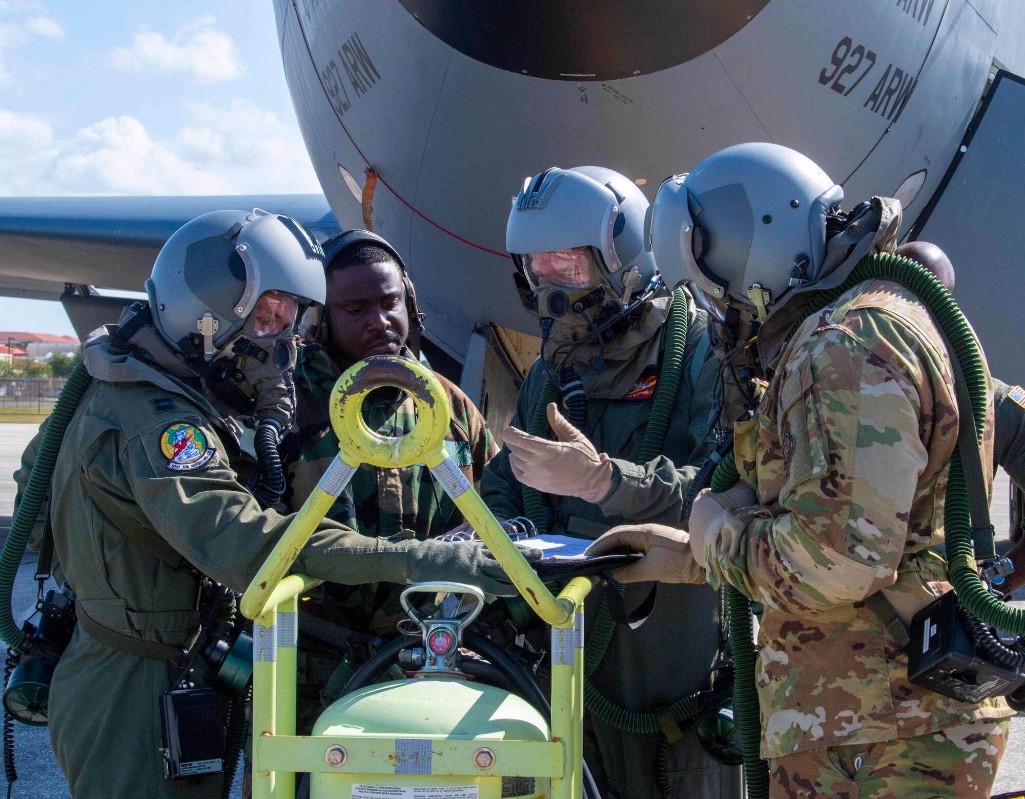 Aircrew and maintenance Airmen from the 91st Air Refueling Squadron (ARS) perform KC-135 Stratotanker aircraft pre-flight checks while wearing aircrew eye and respiratory protection system equipment during a large-scale readiness exercise at MacDill Air Force Base, Florida, May 20, 2021