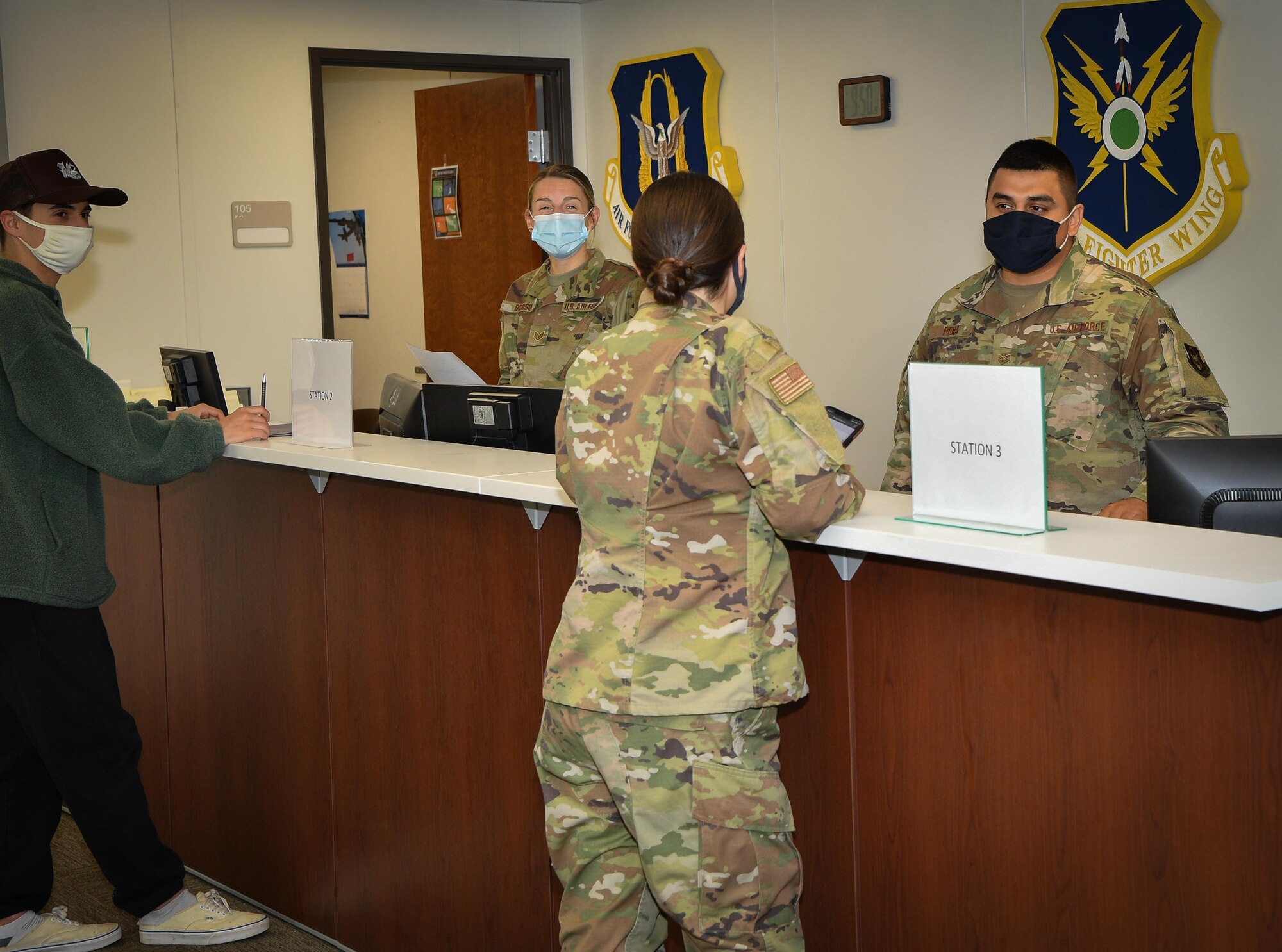 (center) Senior Airman Lexi Smith 301st Fighter Wing Force Support Squadron customer support technician is called up by (right) Staff Sgt. Jose Pena 301 FSS career development NCOIC for her scheduled appointment using the wing's new Queue Kiosk system at U.S. Naval Air Station Joint Reserve Base Fort Worth, Texas. This innovation is meant to help give Airmen back their time so they can focus on mission training and execution. (U.S. Air Force photo by Jeremy Roman)