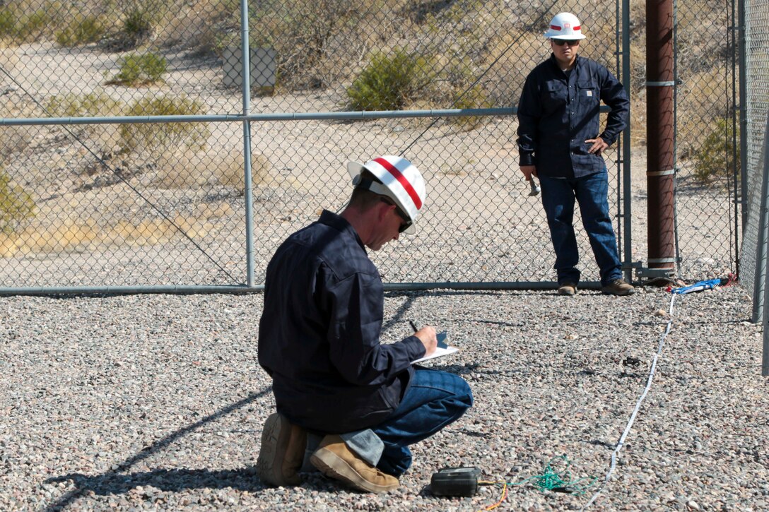 Staff Sgt. Jacob Wratchford (center) and Sgt. Eduardo Delacruz, Alpha Company, 249th Engineer Battalion, U.S. Army Corps of Engineers, are testing a San Carlos Irrigation Project's substation grounding May 19 by testing soil conductivity. The 249th is charged with the rapid deployment of U. S. Army generators to support worldwide requirements.