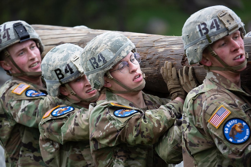 Troops carry a log.