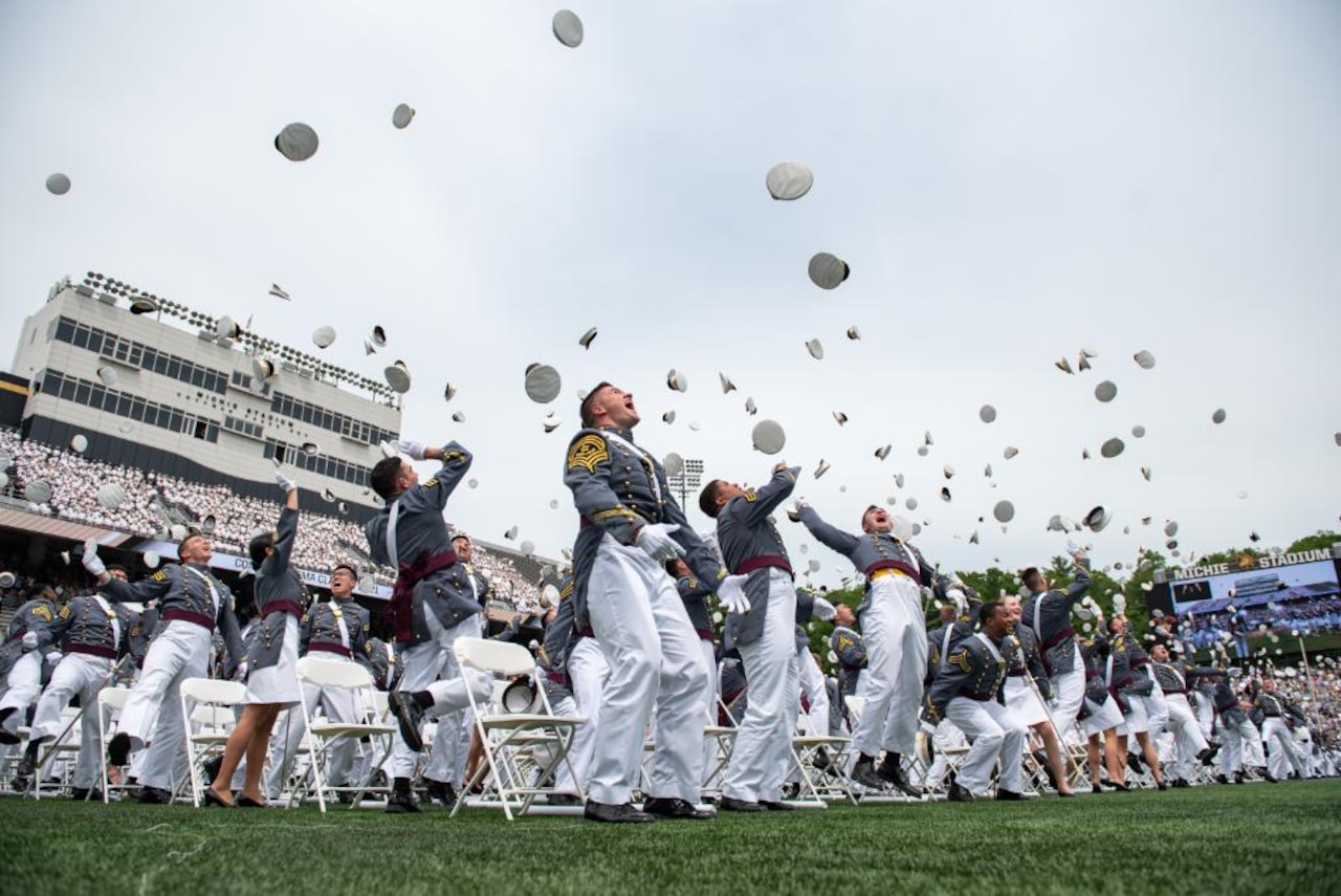 Graduates throw caps in the air at the conclusion of commencement services.