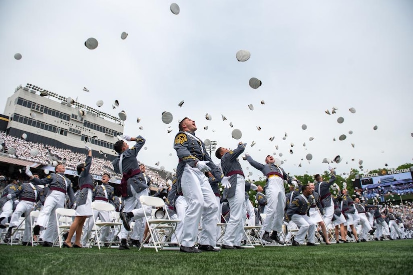 Graduates throw caps in the air at the conclusion of commencement services.