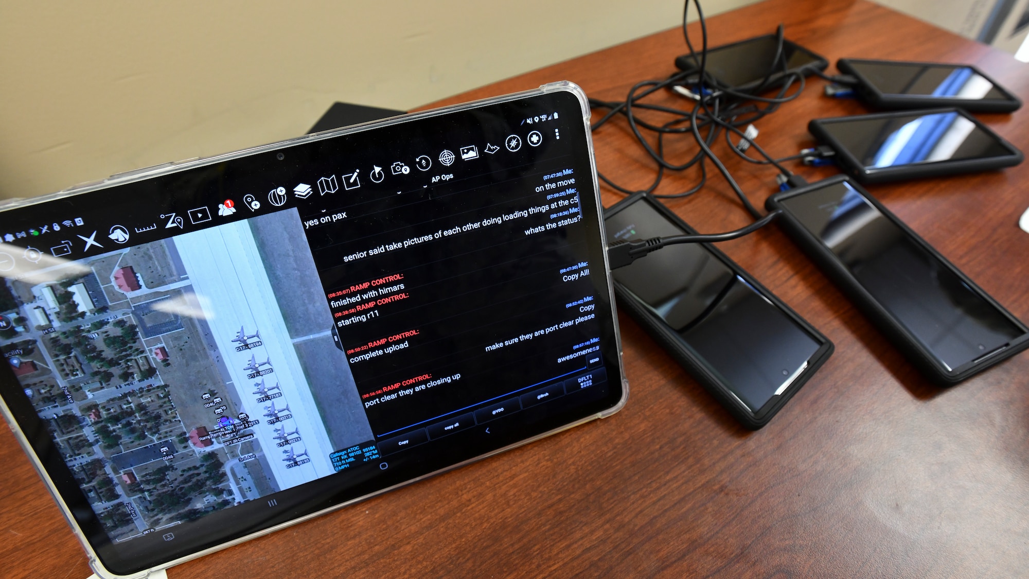 Smartphones and iPads installed with the Android Team Logistics Awareness Switch (ATLAS) lay on a table near the flightline at the Alpena Combat Readiness Training Center, Mich., May 21, 2021. Similar to tracking systems like FedEx or Amazon, the app enables Mobility Airmen to see the real-time status updates of equipment at any time or place. During Exercise Mobility Guardian 2021 ATLAS was tested for the first time in a uncontrolled environment.