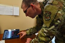 U.S. Air Force Tech. Sgt. Travis Alton, an Air Mobility Command command manager for Transportation Innovations, Systems and Futures, explains how to use the Android Team Logistics Awareness Switch during Exercise Mobility Guardian 2021 at the Alpena Combat Readiness Training Center, Michigan, May 21, 2021. AMC is collaborating with the Air Force Research Laboratory to modernize the logistics force, developing digitally-adept Airmen by updating processes which have remained largely unchanged for more than a decade. (U.S. Air Force video by Tech. Sgt. Kentavist P. Brackin)