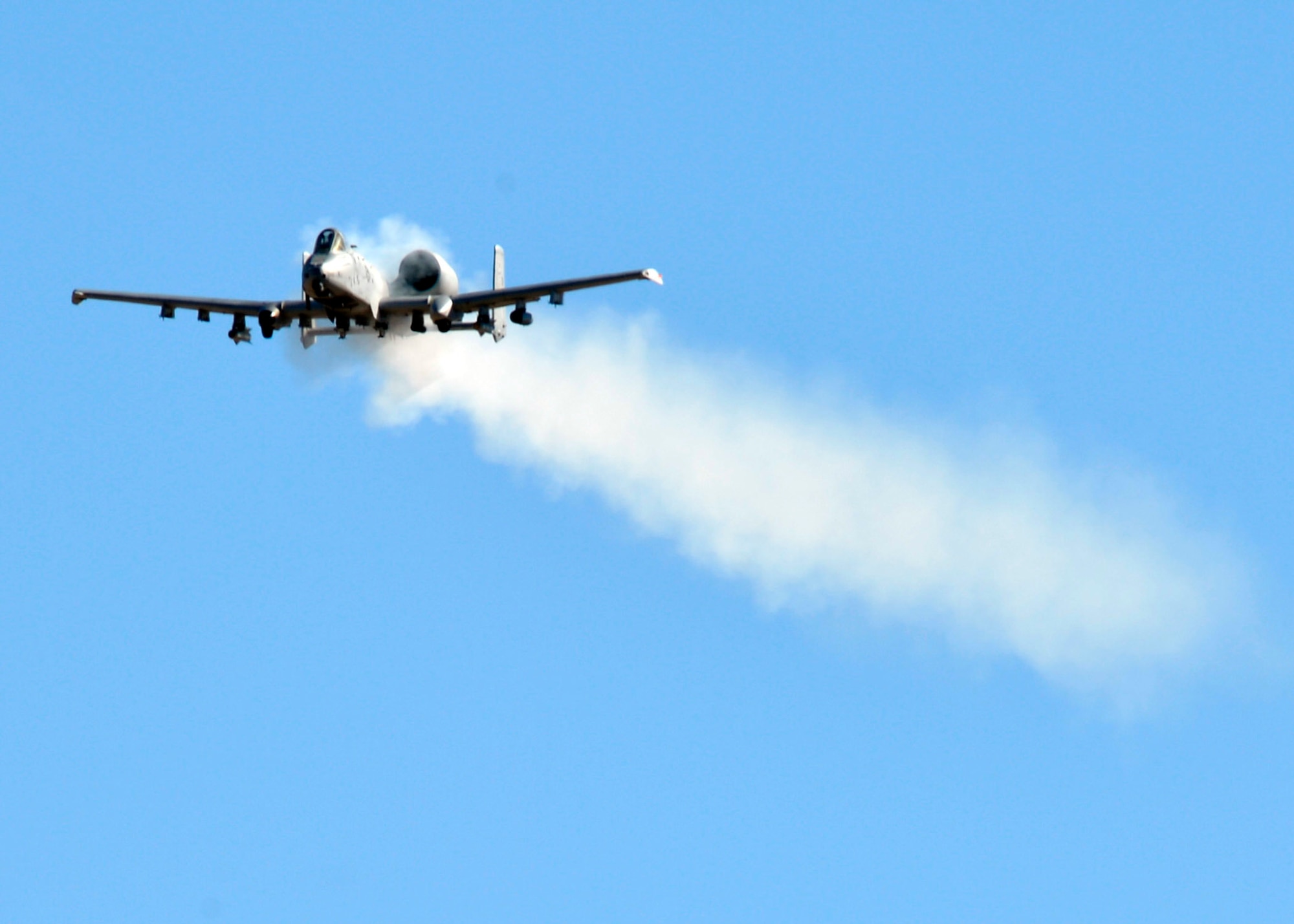 An A-10 Thunderbolt II from Davis Monthan Air Force Base fires off its 30mm gun during a training mission at the Barry Goldwater Range, Gila Bend Air Force Auxiliary Field, Arizona, Nov. 20, 2014. The A-10 Thunderbolt is also known as the Warthog, the "flying gun" and the Tankbuster. The aircraft was used extensively during Operation Desert Storm, in support of Nato operations in response to the Kosovo crisis, in Operation Enduring Freedom in Afghanistan and in Operation Iraqi Freedom. (U.S. Air Force photo by Senior Airman Devante Williams)