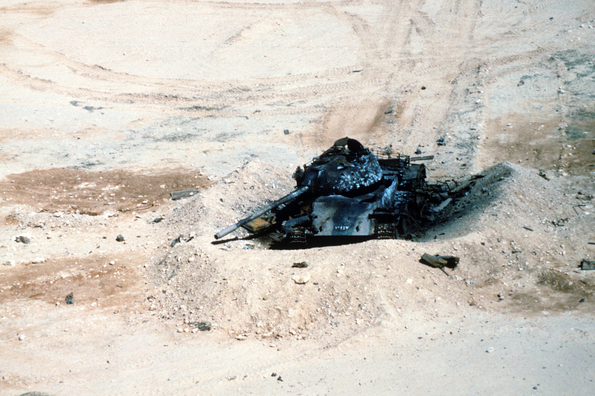 An Iraqi T-55 tank lies in ruins in the aftermath of an Allied bombing attack during Operation Desert Storm.