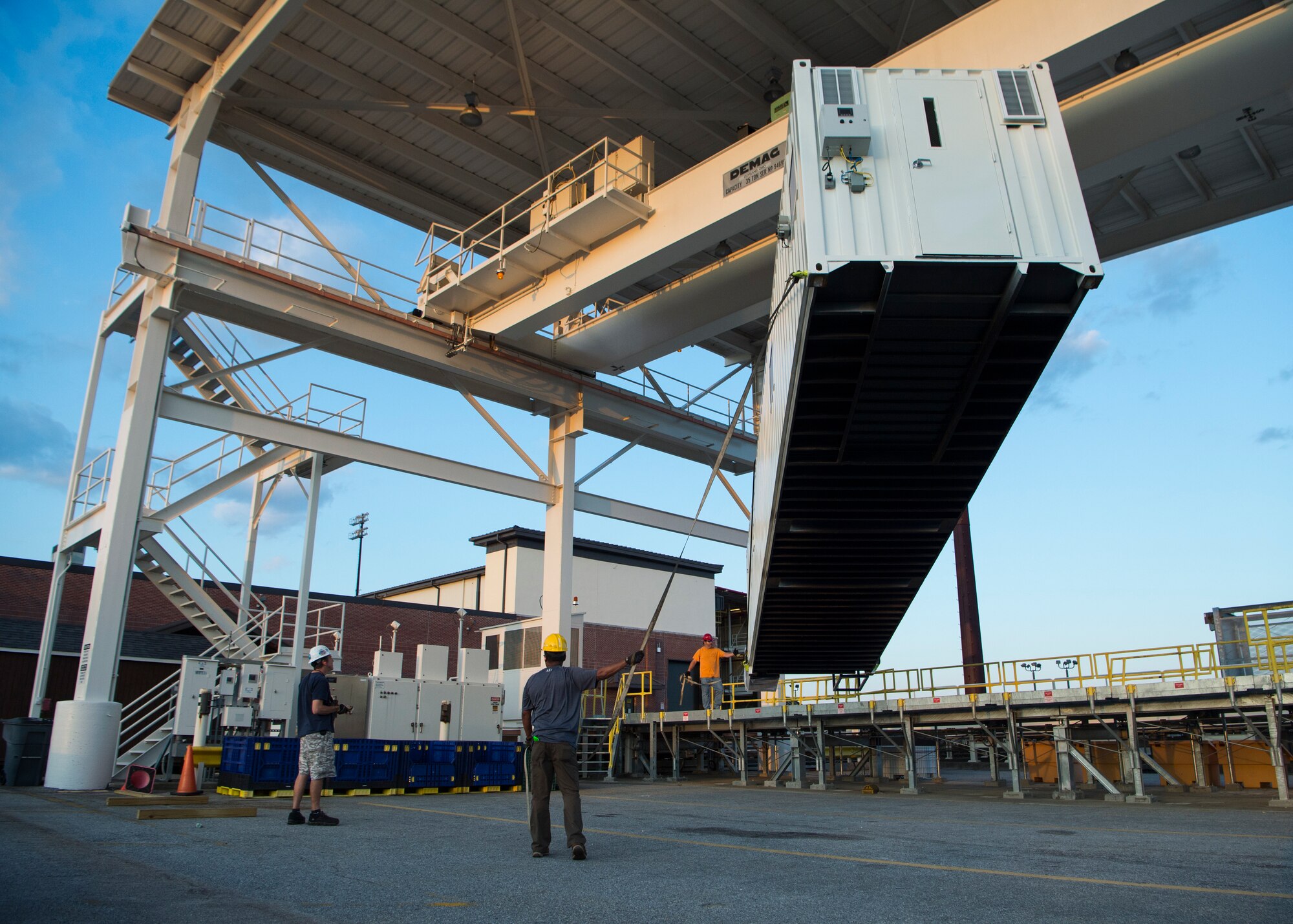 Civilians from the 437th Aerial Port Squadron position a Negatively Pressurized Conex prototype after its delivery to Joint Base Charleston, S.C., April 21, 2020. The NPC was rapidly developed and designed to fit inside both C-5 and C-17 aircraft to enable safe transport of up to 28 patients, as well as teams of medical professionals to medical facilities around the globe. (U.S. Air Force photo by Staff Sgt. Chris Drzazgowski)