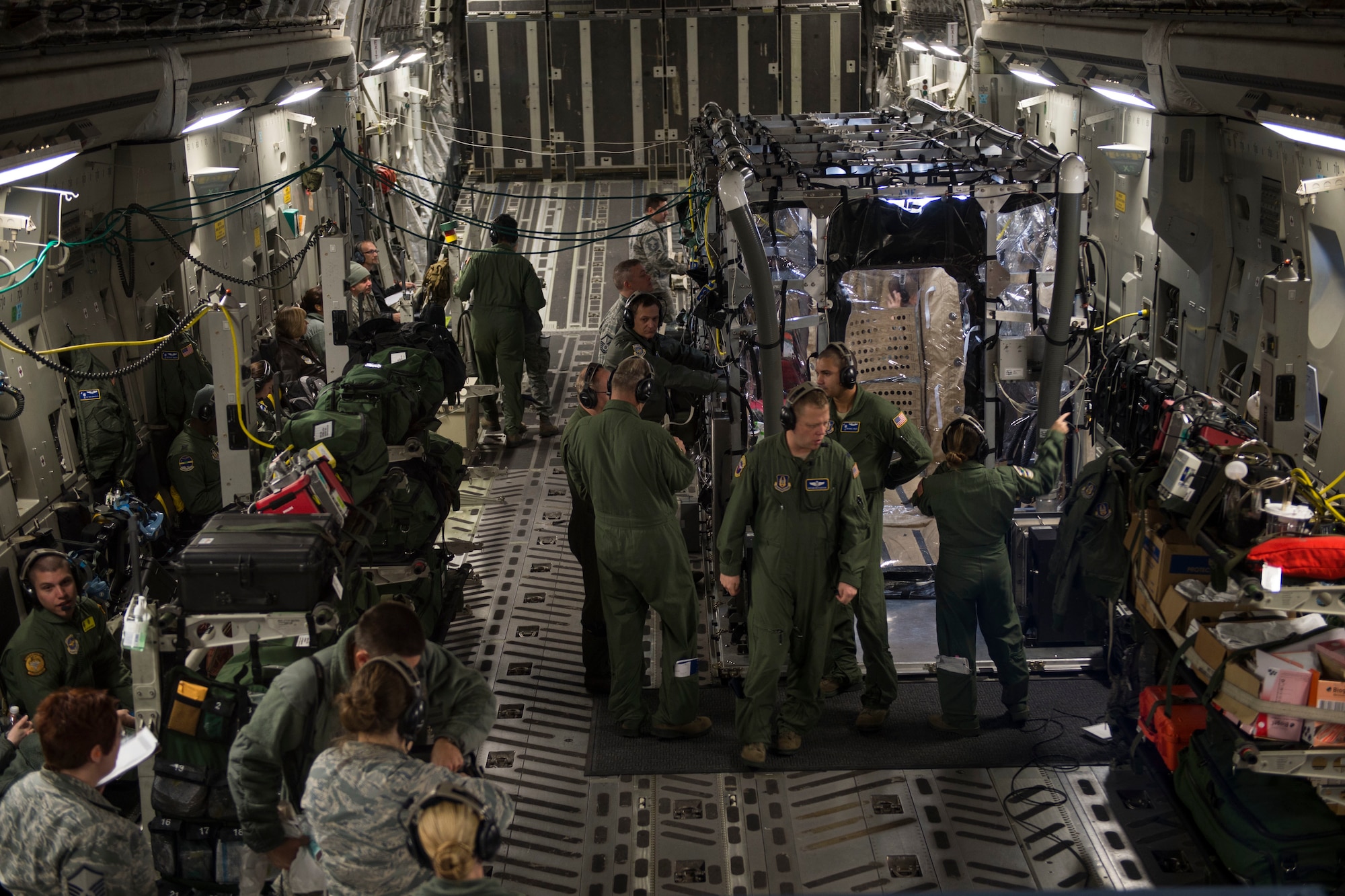 Airmen from Joint Base Charleston and the Air Force Operational Test and Evaluation Center build, test and evaluate the Transport Isolation System (TIS) at JB Charleston, Dec. 13, 2014. The TIS is a self-contained module system that can be used with either two or three sections, depending on aircraft space. It will be used to safely transport patients with an infectious disease. (U.S. Air Force photo by Airman 1st Class Taylor Queen/Released)