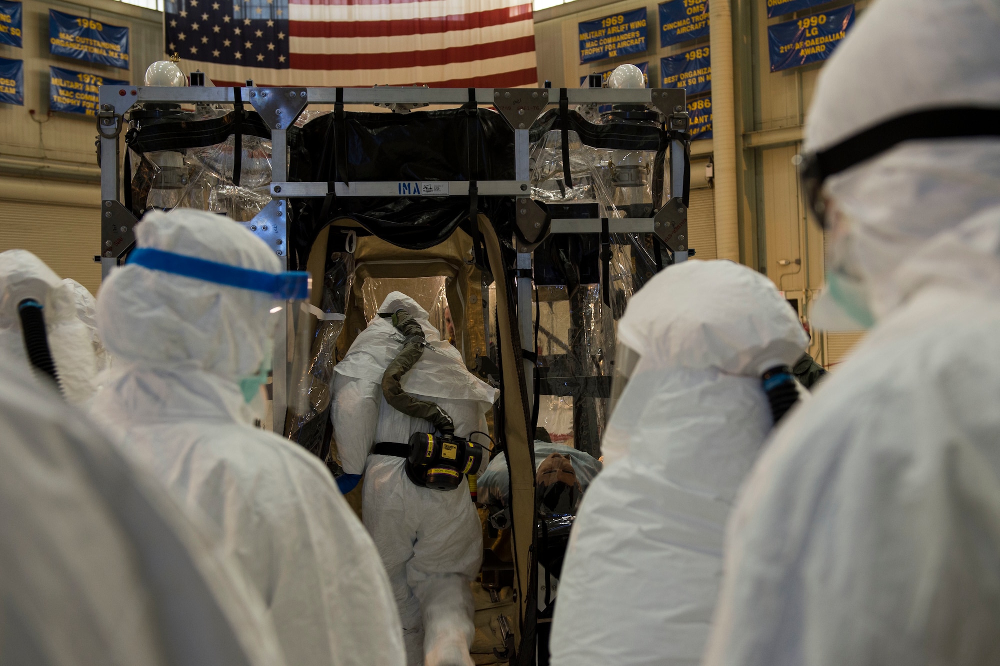 Airmen from Joint Base Charleston and the Air Force Operational Test and Evaluation Center build, test and evaluate the Transport Isolation System (TIS) at JB Charleston, Dec. 10, 2014. The TIS is a self-contained module system that can be used with either two or three sections, depending on aircraft space. It will be used to safely transport patients with an infectious disease. (U.S. Air Force photo by Airman 1st Class Taylor Queen/Released)