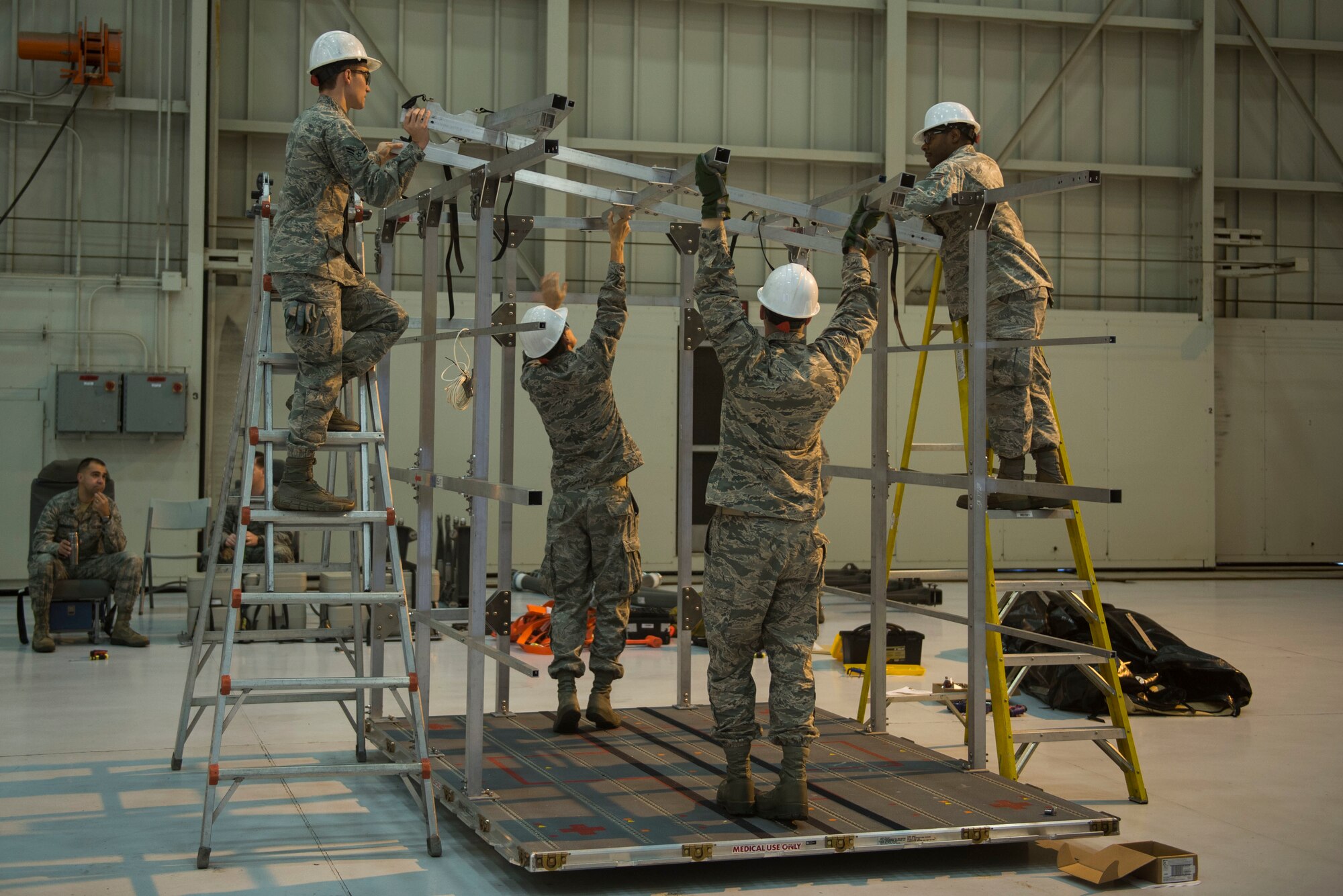 Airmen from Joint Base Charleston and the Air Force Operational Test and Evaluation Center build, test, and evaluate the Transport Isolation System (TIS) at JB Charleston, Dec. 4,2014. The TIS is a self-contained module system that can be used with either two or three sections, depending on aircraft space. It will be used to safely transport patients with an infectious disease.(U.S. Air Force photo by Airman 1st Class Taylor Queen/Released)