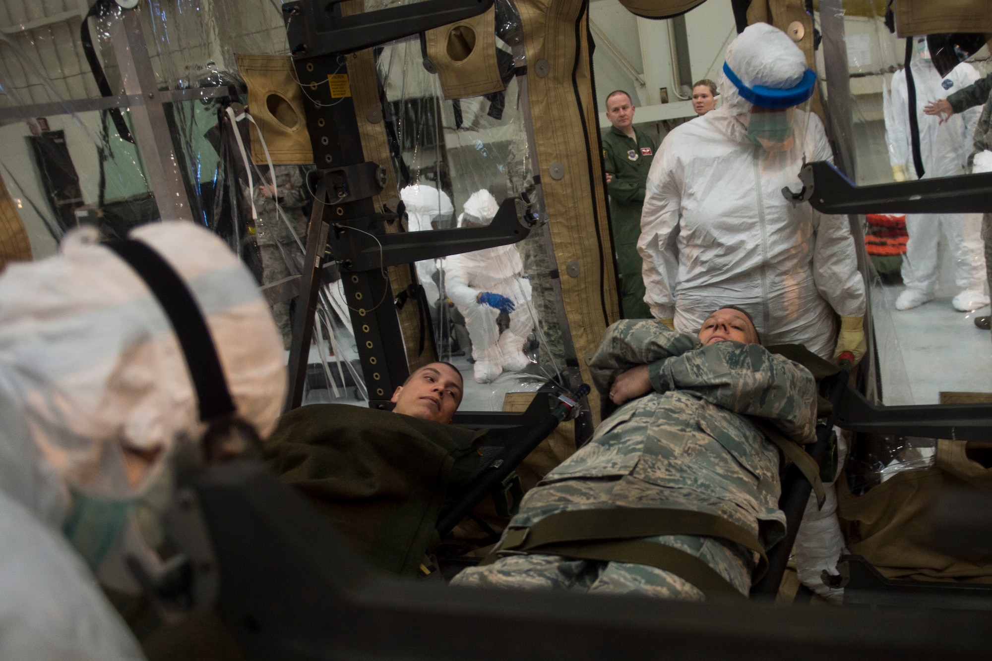 Airmen from Joint Base Charleston and the Air Force Operational Test and Evaluation Center build, test and evaluate the Transport Isolation System (TIS) at JB Charleston, Dec. 10, 2014. The TIS is a self-contained module system that can be used with either two or three sections, depending on aircraft space. It will be used to safely transport patients with an infectious disease. (U.S. Air Force photo by Airman 1st Class Taylor Queen/Released)