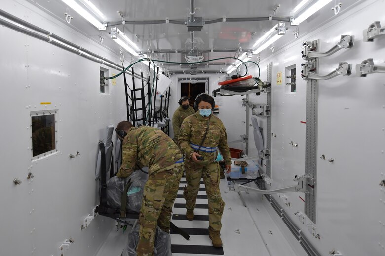 U.S. Air Force Airmen assigned to the 86th Aeromedical Evacuation Squadron inspect and prepare to set up the inside of a Negatively Pressurized Conex-Lite at Ramstein Air Base, Germany, Dec. 18, 2020. The NPC-L is a smaller version of the Negatively Pressurized Conex, an isolated containment chamber intended to transport individuals with infectious diseases like COVID-19. The 86th AES used the NPC-L in a COVID-19 patient movement training that ended with a proof-of-concept flight. (U.S. Air Force photo by Senior Airman John R. Wright)