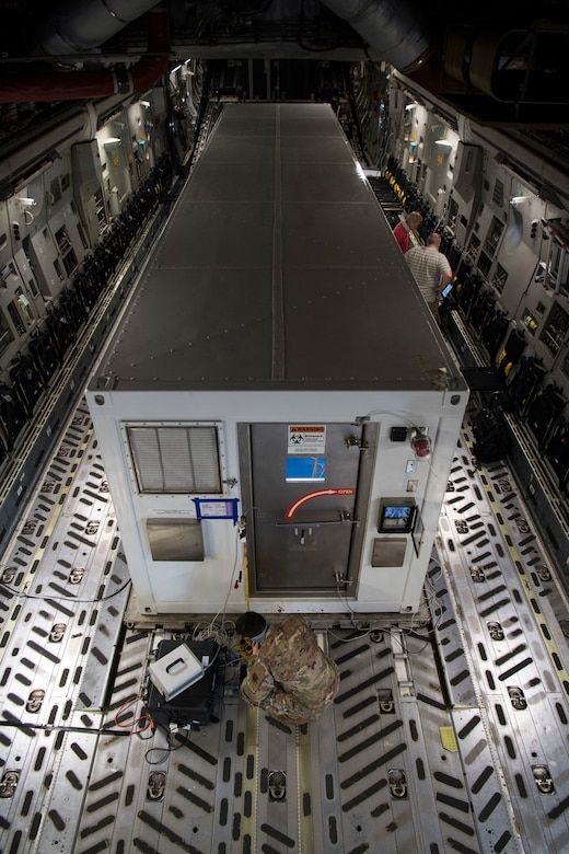 U.S. Air Force Capt. Conor Favo, 28th Test and Evaluation Squadron division chief, Victor Arca, 28th TES senior test engineer, and Gabriel Intano, Army Public Health Center microbiologist, conduct data collection from a Portable Bio-Containment Module on a C-17 Globemaster III at Joint-Base Charleston, S.C., April 15, 2020. Members from the 28th TES and Army PHC tested the PBCM, which will be exercised regularly to transport COVID patients and medical personnel, all while ensuring the aircrew is impervious to risk of infection. (U.S. Air Force photo by Staff Sgt. Chris Drzazgowski)