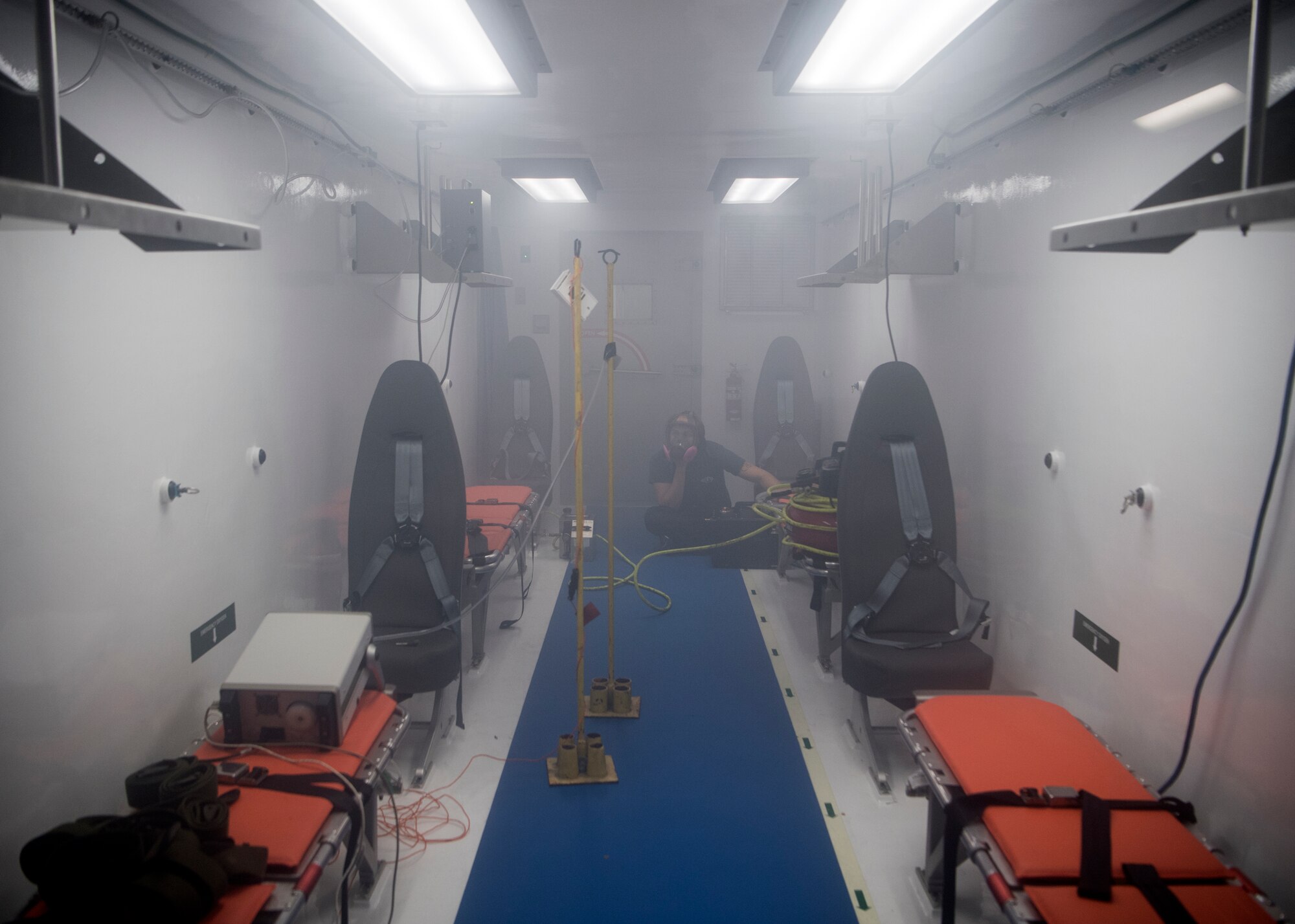 An aerosol vapor is released into a Portable Bio-Containment Module, loaded onto a C-17 Globemaster III, to test its ability to contain pathogens at Joint Base Charleston, S.C., April 15, 2020. Members from the 28th TES and Army Public Health Center tested the PBCM, which will be exercised regularly to transport COVID patients and medical personnel, all while ensuring the aircrew is impervious to risk of infection. (U.S. Air Force photo by Staff Sgt. Chris Drzazgowski)