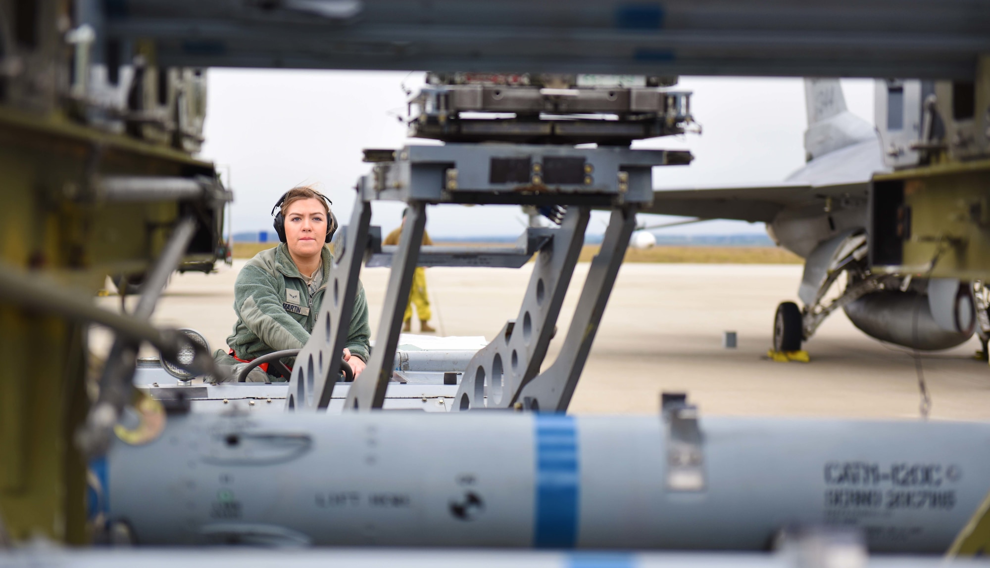 U.S. Air Force Airman 1st Class Nevada Martin, 52nd Aircraft Maintenance Squadron weapons load team 
member, operates a bomb lift truck to attach an AIM-120 missile onto an F-16 Fighting Falcon during an 
Agile Combat Employment exercise at Spangdahlem Air Base, Germany, Jan. 14, 2020. This exercise 
simulated a forward deployed environment for operating without prepositioned equipment. (U.S. Air 
Force photo by Staff Sgt. Joshua R. M. Dewberry)