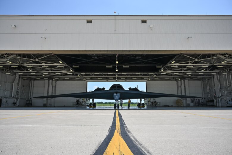 Senior Airmen Cutter Delarosa, left, and Tyler Holzinger, both B-2 Spirit crew chiefs assigned to the 509th Aircraft Maintenance Squadron, await the completion of a pilot preflight check below their aircraft at Whiteman Air Force Base, Missouri, June 17,  2020. Two B-2s took off from Whiteman AFB to support a long-distance training mission that demonstrates U.S. capability to command, control and conduct operations around the globe in support to allies and partner nations. (U.S. Air Force photo by Tech. Sgt. Alexander W. Riedel)