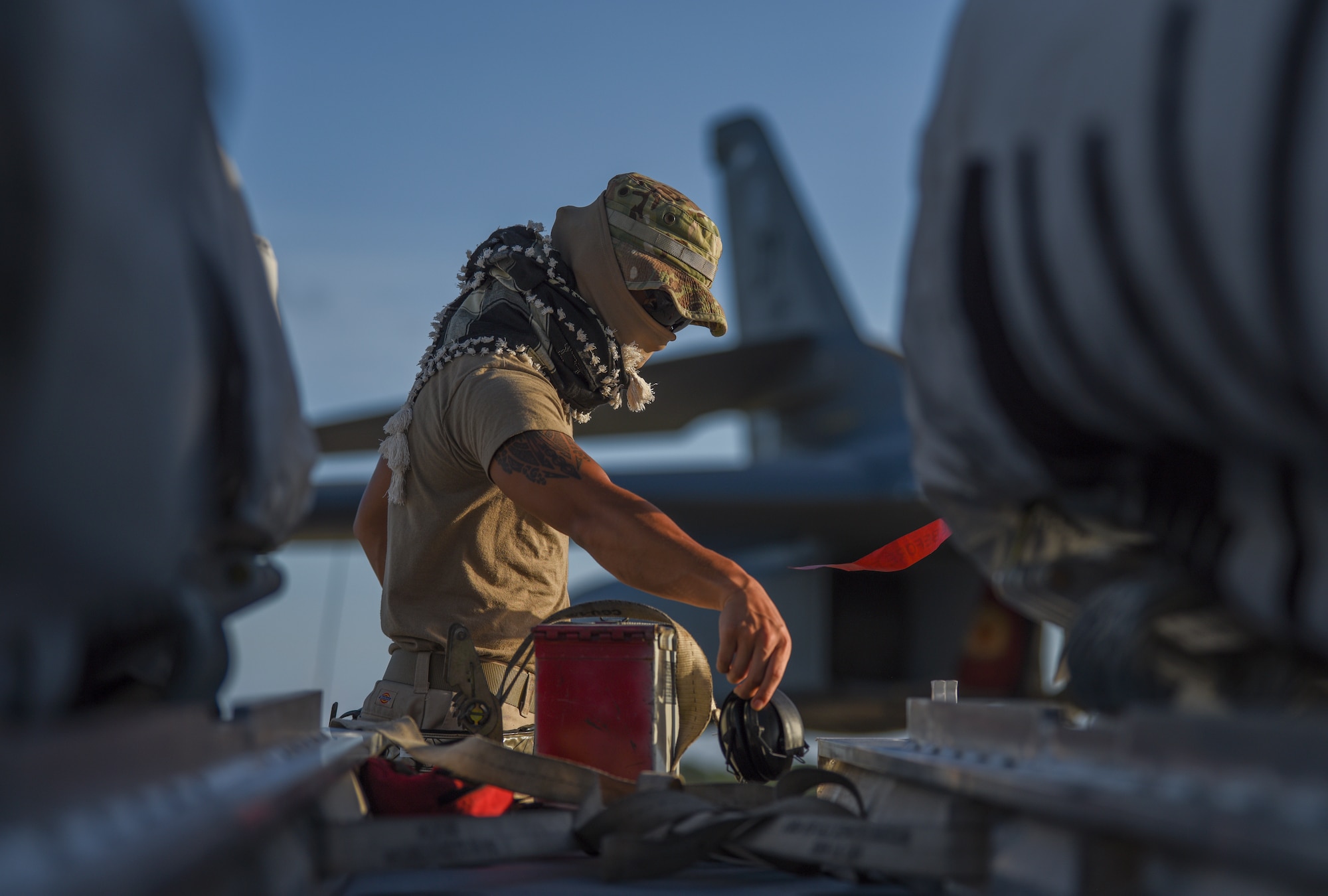 Senior Airman Vincent Llubit, 9th Expeditionary Bomb Squadron Aircraft Maintenance Unit weapons load crew member, grabs hearing protection off of a trailer that held two joint air-to-surface standoff missile into a B-1B Lancer on the flightline at Anderson Air Force Base, Guam, May 9, 2020. The B-1B can carry more than 74,000 lbs of munitions, which is the largest payload in the Air Force inventory. (U.S. Air Force photo by Senior Airman River Bruce)