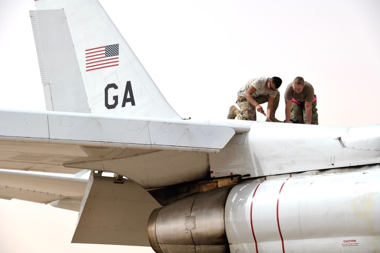 U.S. Air Force crew chiefs assigned to the 379th Expeditionary Maintenance Squadron, conduct maintenance on an E-8C Joint Surveillance Target Attack Radar System (JSTARS) on the Prince Sultan Air Base, Kingdom of Saudi Arabia, March 8, 2020. The JSTARs forward deployed to PSAB from Al Udeid Air Base, Qatar as part of an agile combat employment mission meant to test the squadron’s ability to conduct missions in the region from an austere location. (U.S. Air Force photo by Tech. Sgt. Michael Charles)