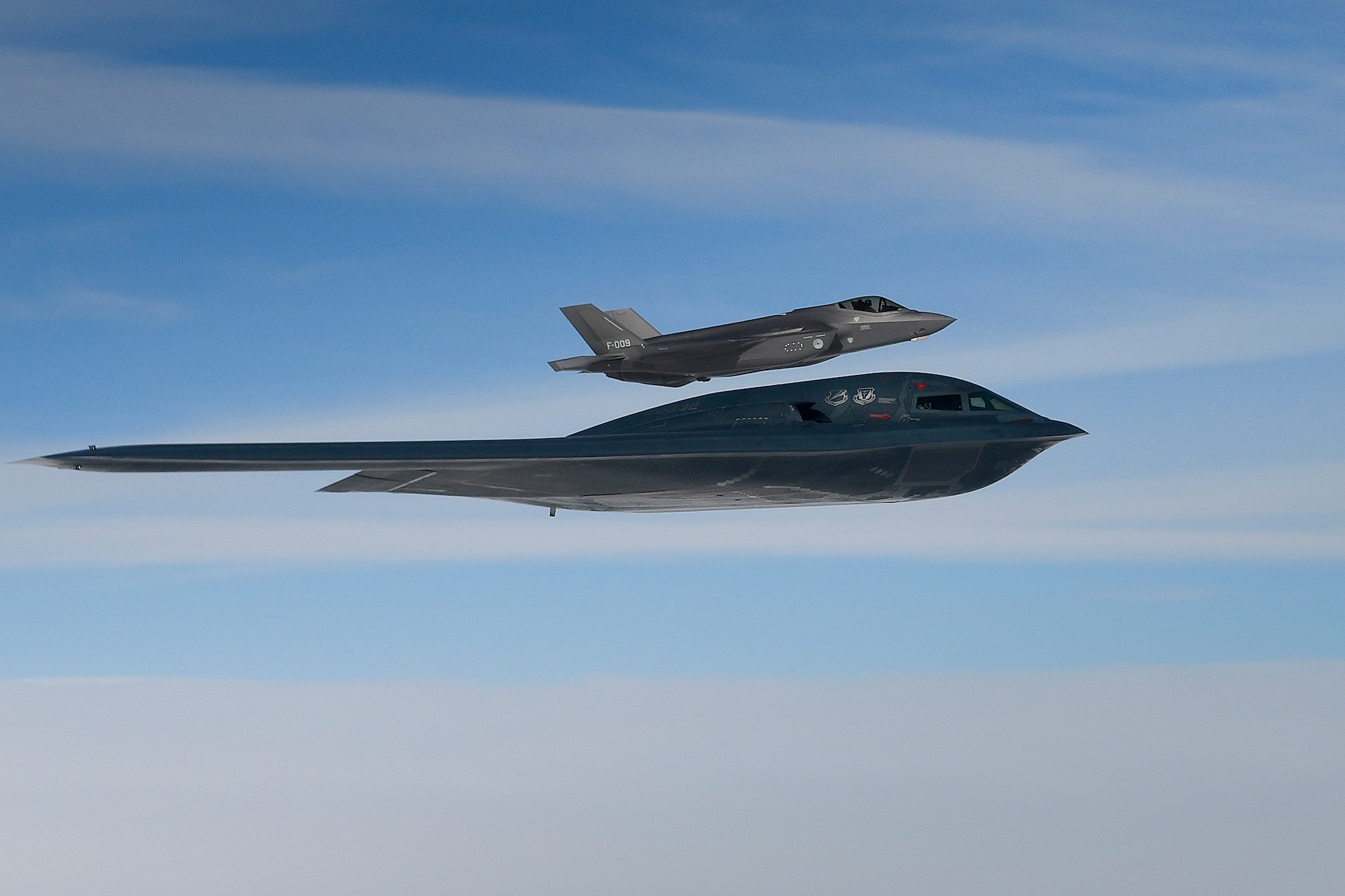 A U.S. Air Force B-2A Spirit assigned to the 509th Bomb Wing at Whiteman Air Force Base, Mo., and a Royal Netherlands Air Force F-35A Lightning II conduct aerial operations in support of Bomber Task Force Europe 20-2 over the North Sea, March 18, 2020. Bomber missions provide opportunities to train and work with NATO allies and theater partners in combined and joint operations and exercises. (U.S. Air Force photo by Master Sgt. Matthew Plew)