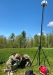 Soldiers set up communications equipment known as tactical video downlink.
