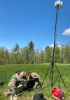 Soldiers set up communications equipment known as tactical video downlink.