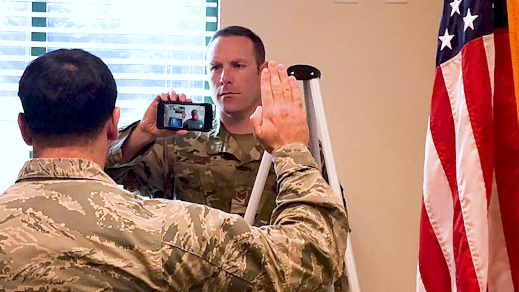 Air National Guard recruiter Kevin O’Brien facilitates a military enlistment utilizing mobile video technology.