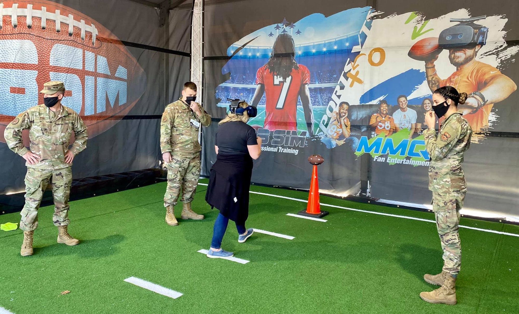 Total Force recruiters assisted a fan with the AIR RAID QB SIM Experience at the Super Bowl LV Experience outside of Raymond James Stadium in Tampa, Florida, Jan. 31, 2021. Air Force recruiters deployed the AIR RAID QB SIM Experience as part of their recruiting efforts. This virtual reality and sensor technology is used to train quarterbacks at both the college and pro level. In the experience, visitors are playing against an Air Force defense and the stadium featured Raymond James Stadium. (Courtesy photo)