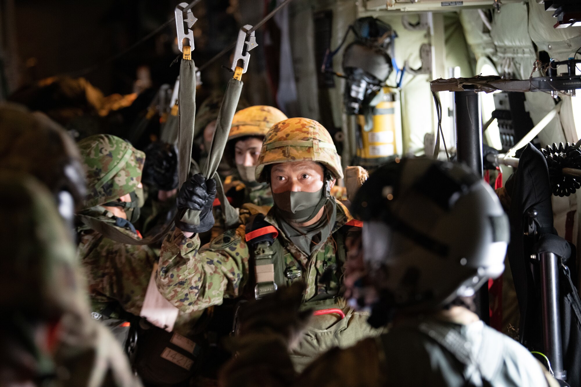 Japan Ground Self-Defense Force soldiers use a static-line in a C-130J Super Hercules aircraft.
