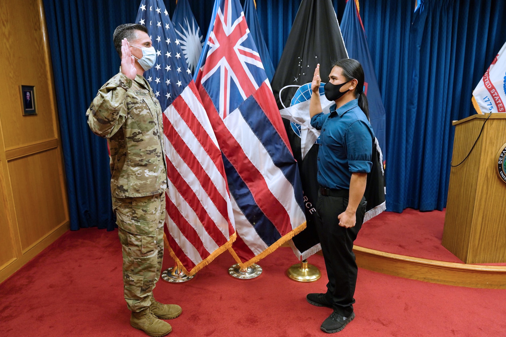 Reyjie Cliff Blando Madriaga, a Hawaiian native, receives the oath of enlistment from U.S. Army Capt. Donald McCoullough, Honolulu Military Entrance Processing Station Officer, as the first Hawaiian Space Force at Joint Base Pearl Harbor-Hickam, Hawaii, March 4, 2021. The oath of enlistment is a promise made by members of the United States Armed Forces to support and defend the Constitution.