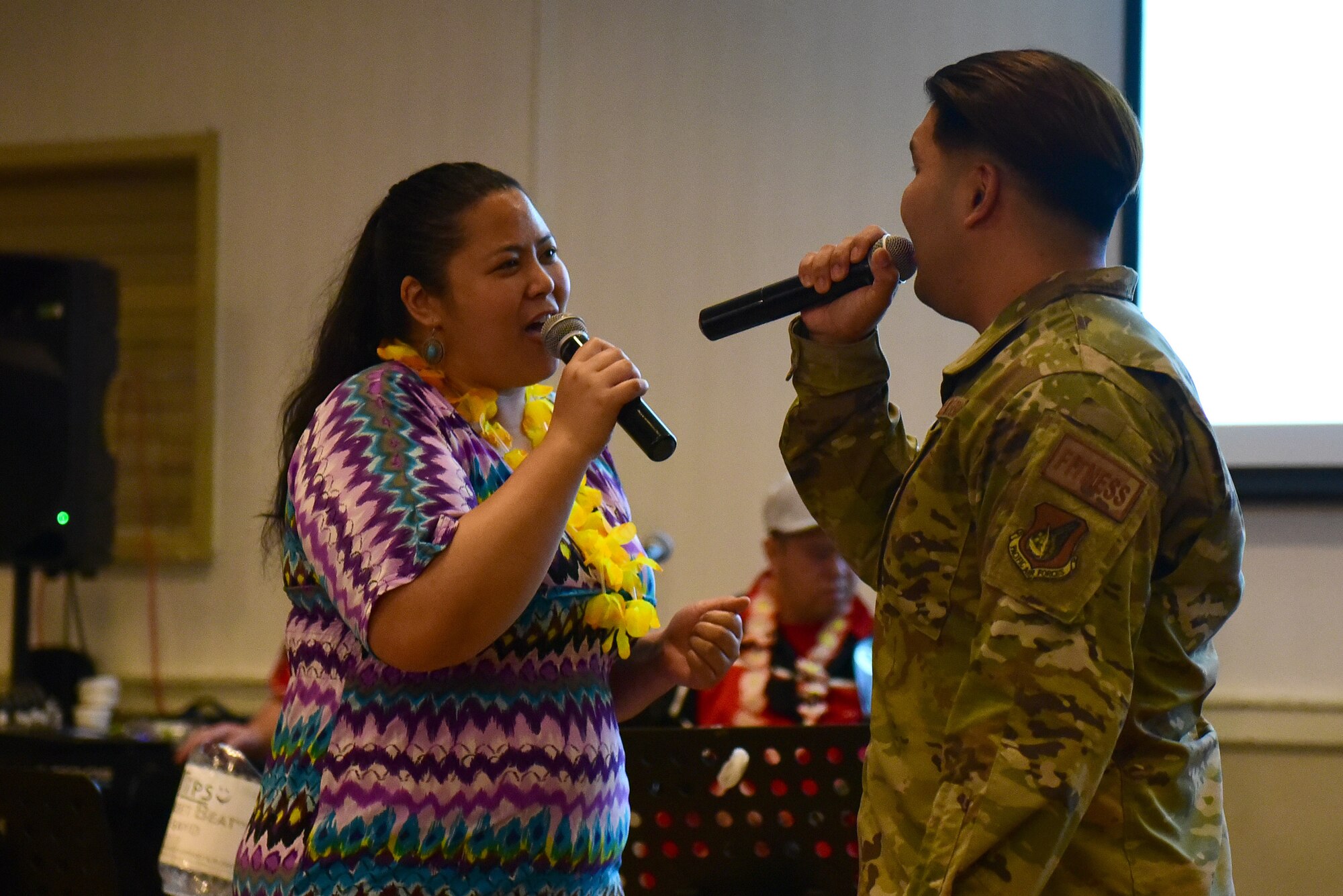 Ricah Quinto, 8th Force Support Squadron community programs specialist, and Staff Sgt. Karl Pasqual, 8th FSS sports director, sing a song during the Asian American and Pacific Islander Heritage Month bash party at Kunsan Air Base, Republic of Korea, May 20, 2021. The bash party was the final event to close out AAPI month which included AAPI cuisine, cultural performances, and guest speakers. (U.S. Air Force photo by Senior Airman Suzie Plotnikov)