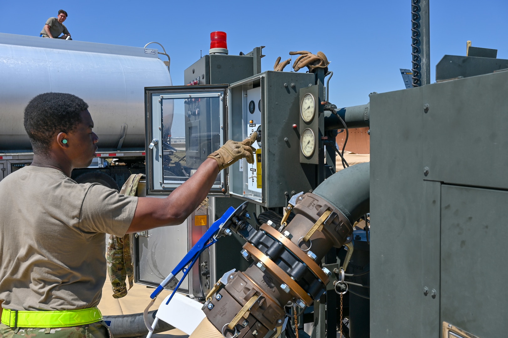 An Air Mobility Command petroleum, oils and lubricants airman pumps fuel into a Fuels Operational Readiness Capability Equipment mobile fuel bladder at Oscoda-Wurtsmith Airport, Oscoda, Michigan, May 18, 2021. FORCE is a 210,000-gallon bladder that is generally setup in deployed environments, negating the need to build hardened tanks or bring fuel trucks, while simultaneously reducing the overall footprint by not leaving hardened facilities behind. (U.S. Air Force photo by Senior Airman Aaron Irvin)