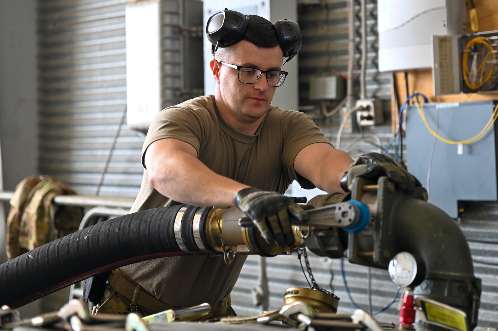 U.S. Air Force Staff Sgt. Christopher Stollings, 436th Logistics Readiness Squadron NCO in charge of fuels distribution, prepares to load fuel into an Aerial Bulk Fuel Delivery System at Alpena Combat Readiness Training Center, Michigan, May 19, 2021. The ABFDS ensures minimal time spent on the ground by expeditiously refueling fighters while keeping engines on. (U.S. Air Force photo by Senior Airman Aaron Irvin)