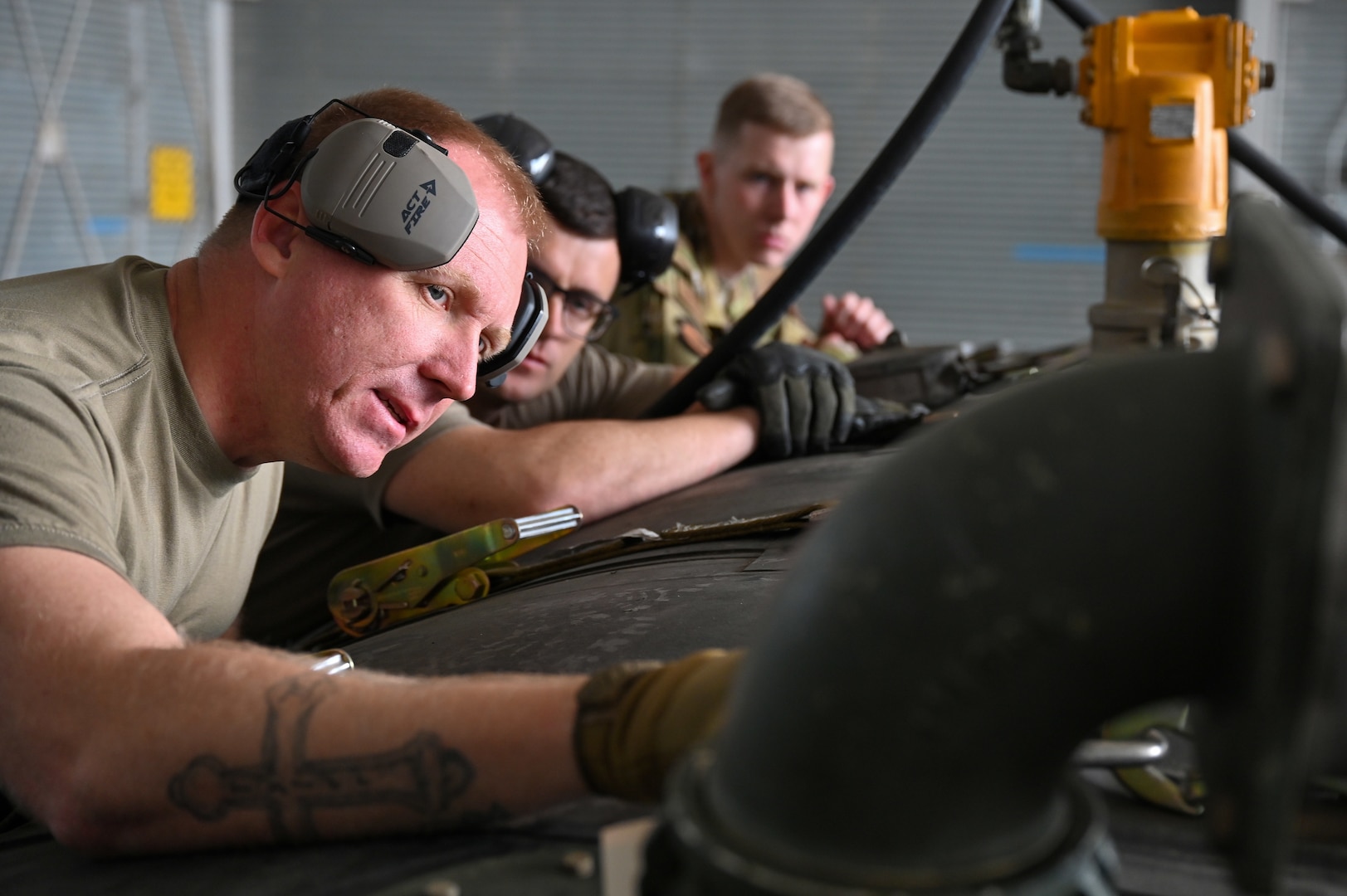 U.S. Air Force Staff Sgt. Kelly Jarrell, 19th Logistics Readiness Squadron fuels distribution supervisor, left, demonstrates how to load fuel into an Aerial Bulk Fuel Delivery System at Alpena Combat Readiness Training Center, Michigan, May 19, 2021. The ABFDS, a portable 3,000-gallon fuel bladder, can be loaded on a C-130J Super Hercules, C-5 Galaxy, or C-17 Globemaster III and transported anywhere around the world. (U.S. Air Force photo by Senior Airman Aaron Irvin)