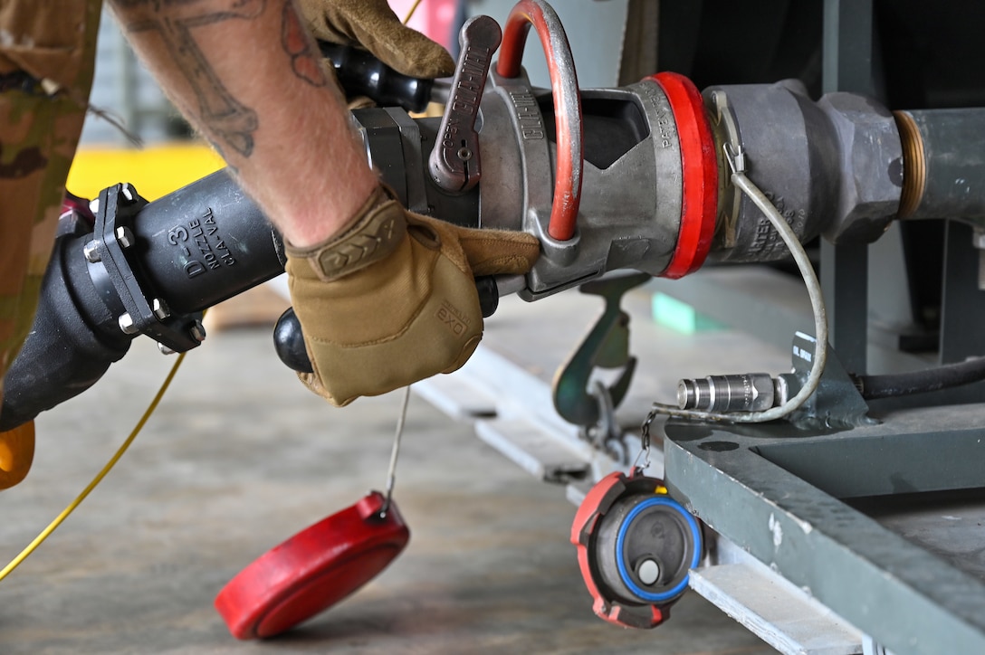 U.S. Air Force Staff Sgt. Kelly Jarrell, 19th Logistics Readiness Squadron fuels distribution supervisor, prepares to load fuel into an Aerial Bulk Fuel Delivery System at Alpena Combat Readiness Training Center, Michigan, May 19, 2021. The ABFDS, a portable 3,000-gallon fuel bladder, can be loaded on a C-130J Super Hercules, C-5 Galaxy, or C-17 Globemaster III and transported anywhere around the world. (U.S. Air Force photo by Senior Airman Aaron Irvin)