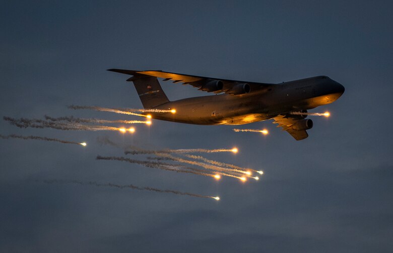 A 436th Airlift Wing C-5M Super Galaxy releases flares during a test May 12, 2021, at Eglin Air Force Base, Fla. The Dover AFB aircraft and aircrew released the flares as part of a two-week defensive countermeasures test program with the 46th Test Squadron.