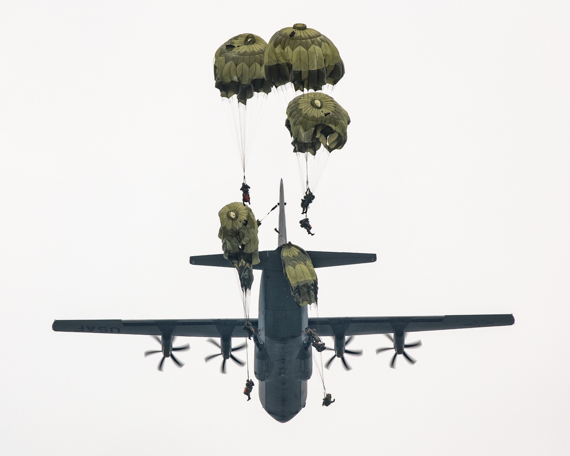 Japan Ground Self-Defense Force soldiers parachute from a C-130J Super Hercules