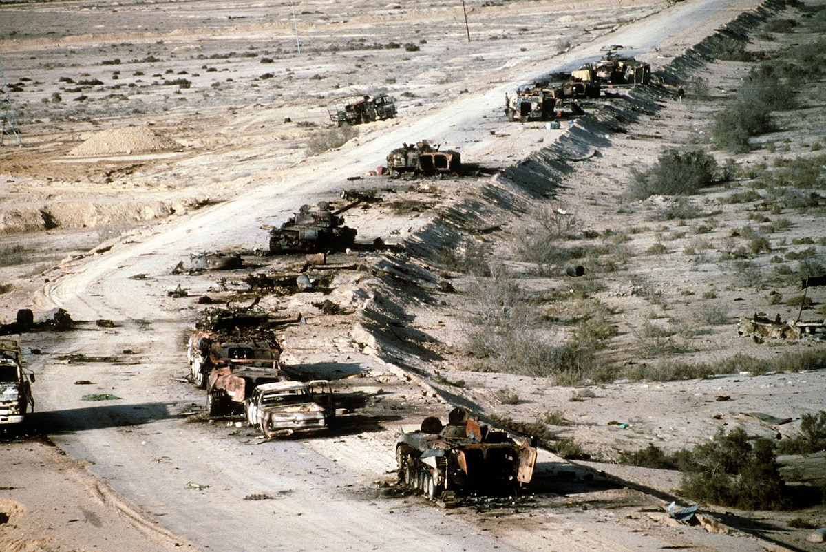 A view of Iraqi armored personnel carriers, tanks and trucks destroyed in a Coalition attack along a road in the Euphrates River Valley during Operation Desert Storm.