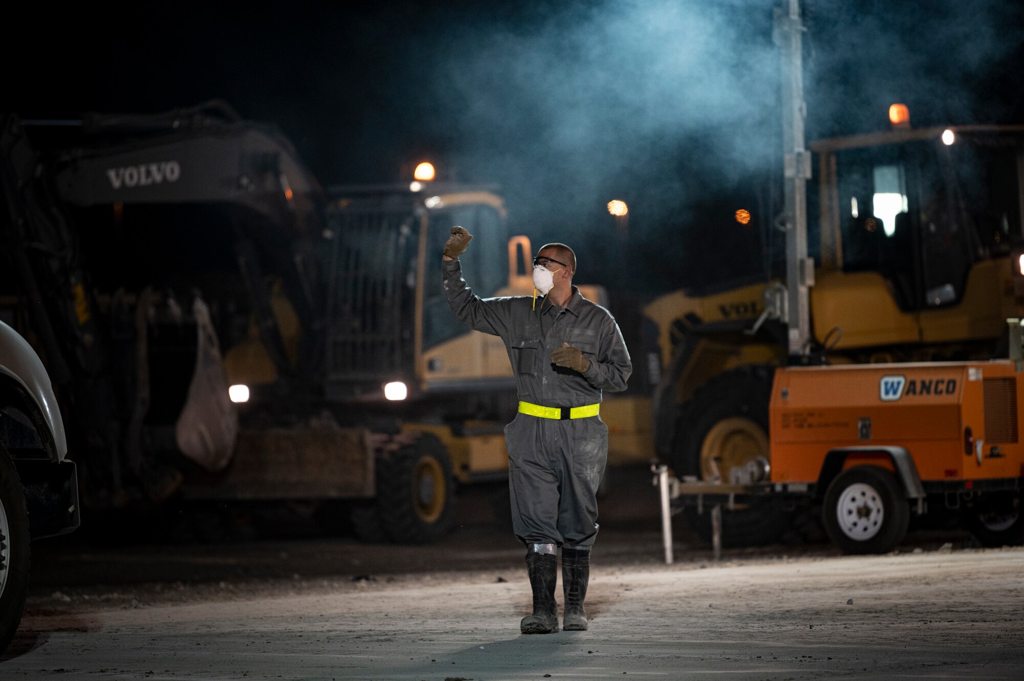 An Airman walks across a concrete pad.