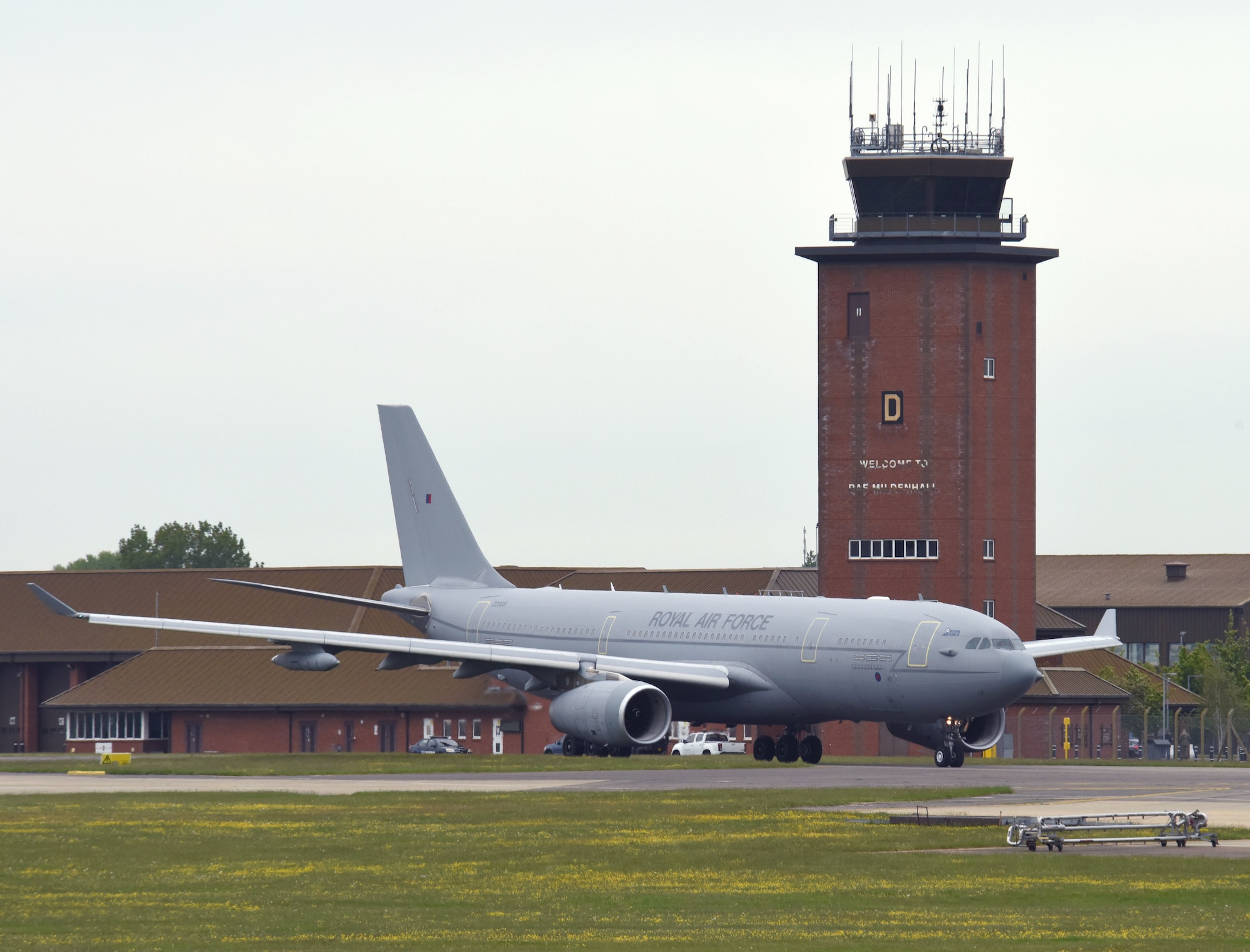 A Royal Air Force A330 Voyager from RAF Brize Norton, England, taxis past the air traffic control tower as it prepares to take off May 20, 2021, at RAF Mildenhall, England. The Voyager took part in an elephant walk and formation flight as part of the European Tanker Symposium which brings tanker crew from NATO countries, along with other U.S. and Canadian forces together to share experiences and knowledge. (U.S. Air Force photo by Karen Abeyasekere)